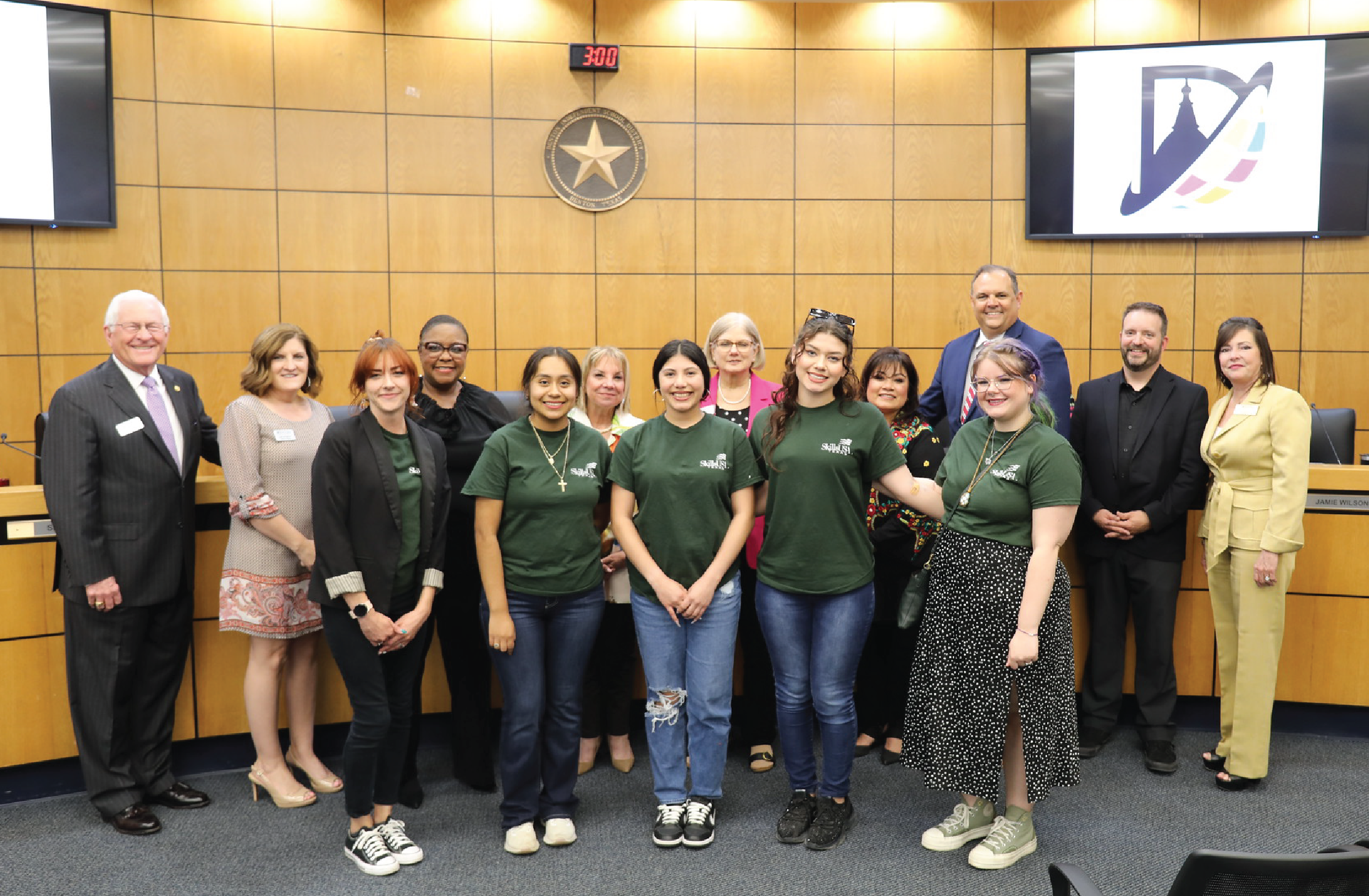 students and staff pose with board of trustees